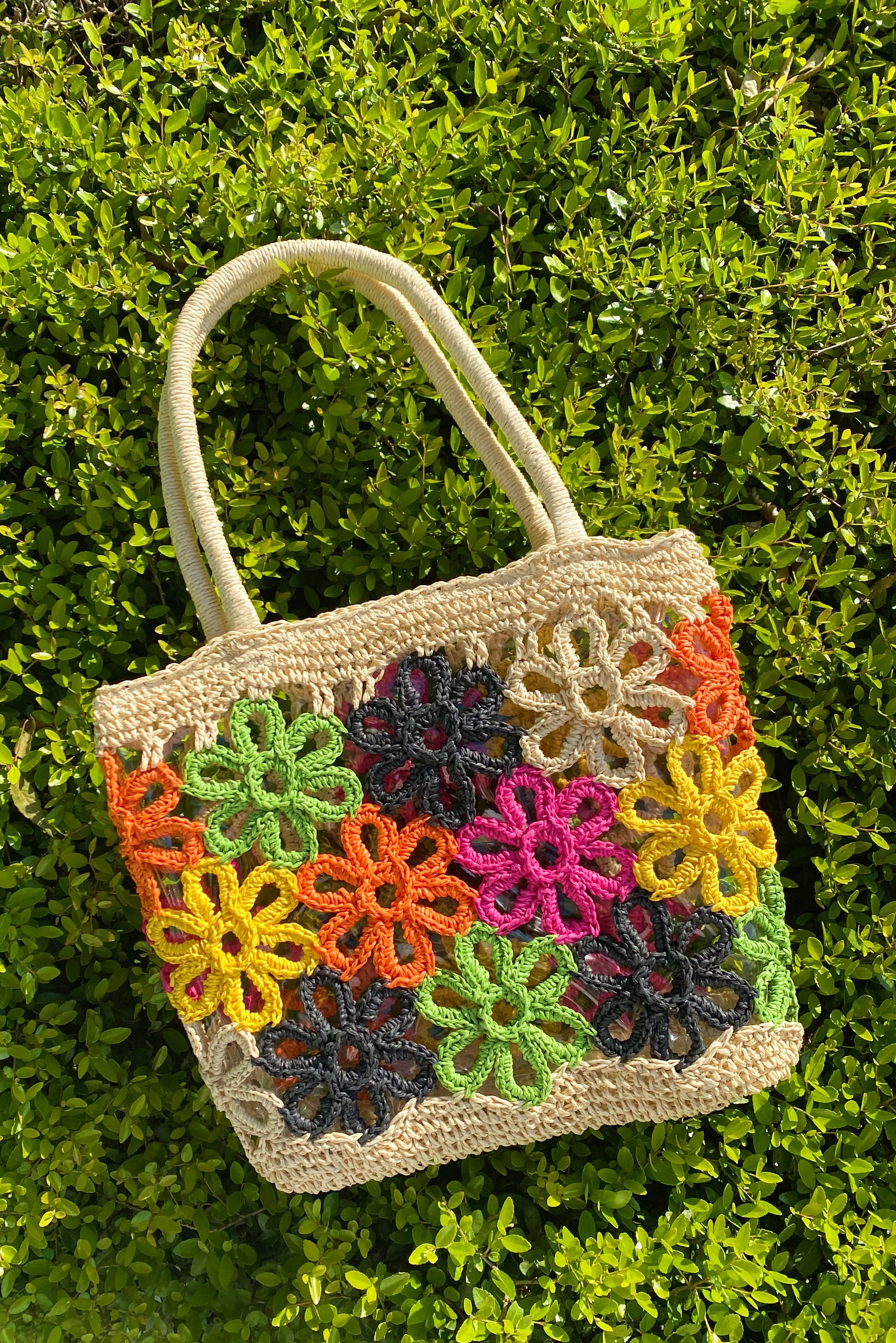 Hand Made Flower Power Tote featuring colorful flower detailing and a clear plastic lining, crafted from durable paper straw.