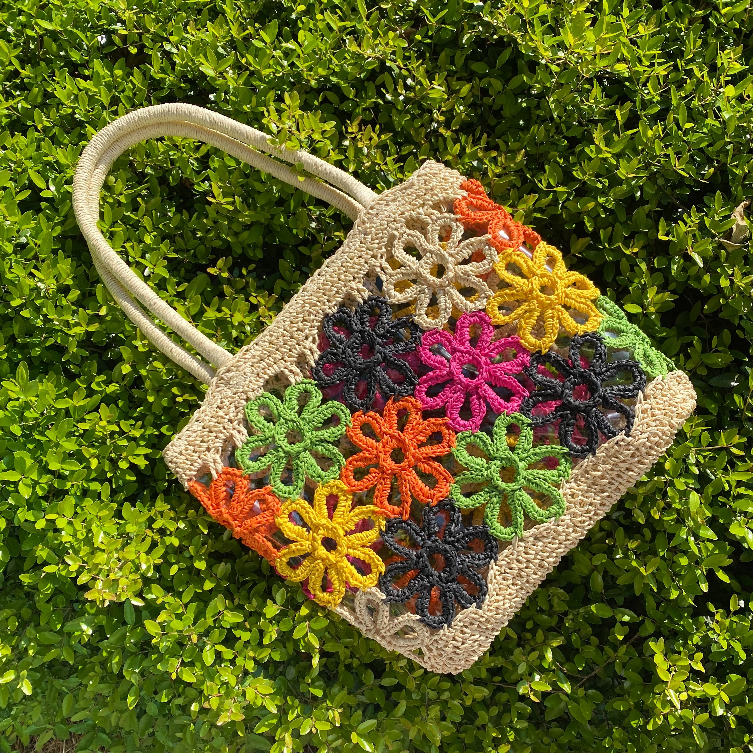 Hand Made Flower Power Tote featuring colorful flower detailing and a clear plastic lining, crafted from durable paper straw.