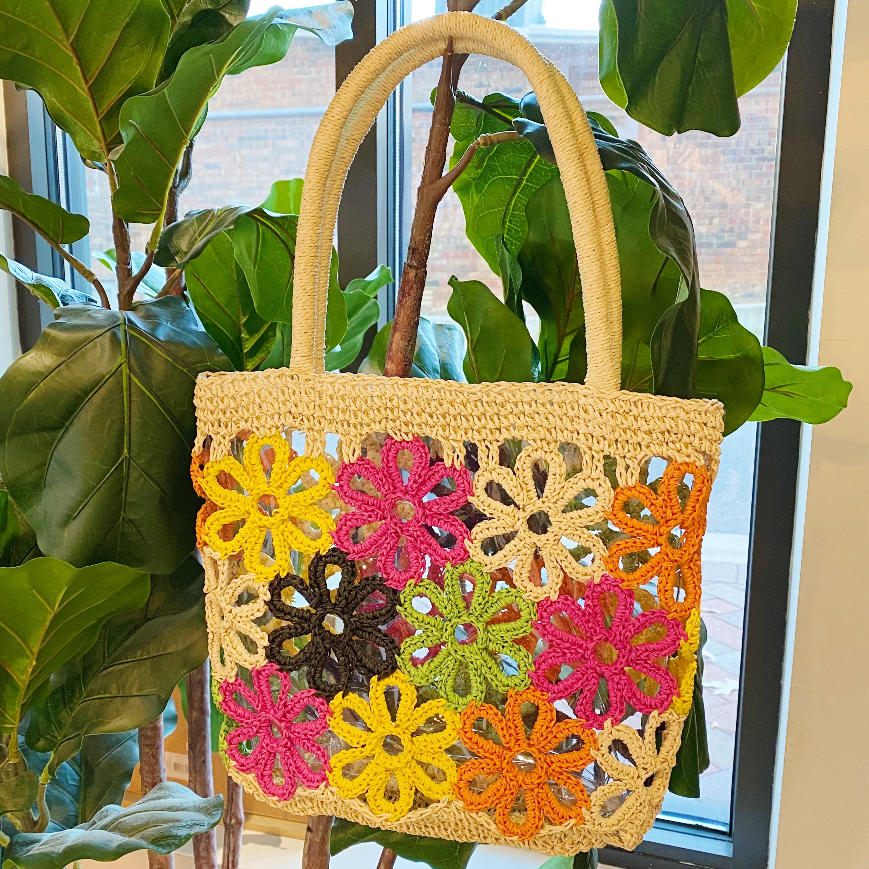 Hand Made Flower Power Tote featuring colorful flower detailing and a clear plastic lining, crafted from durable paper straw.