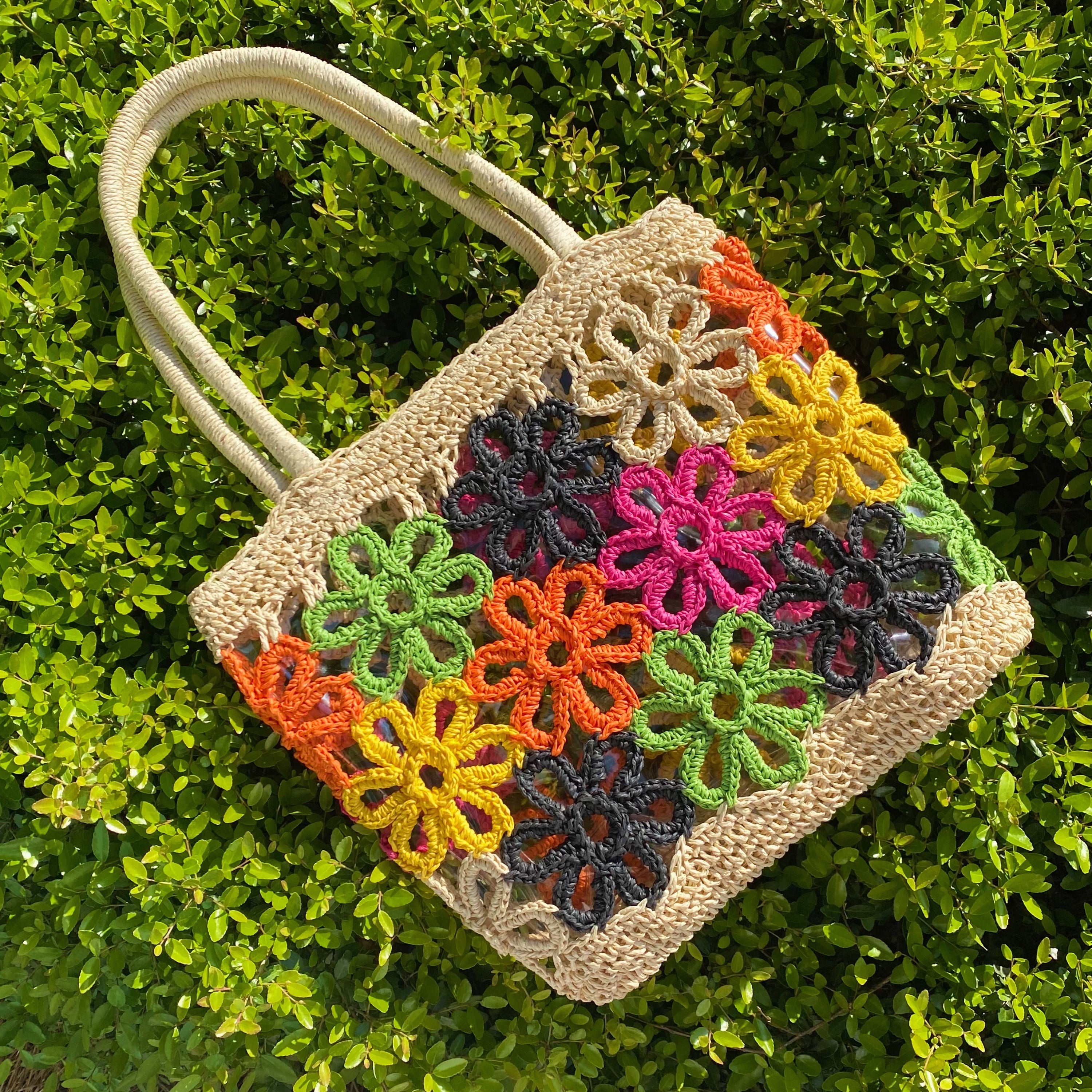 Hand Made Flower Power Tote featuring colorful flower detailing and a clear plastic lining, crafted from durable paper straw.