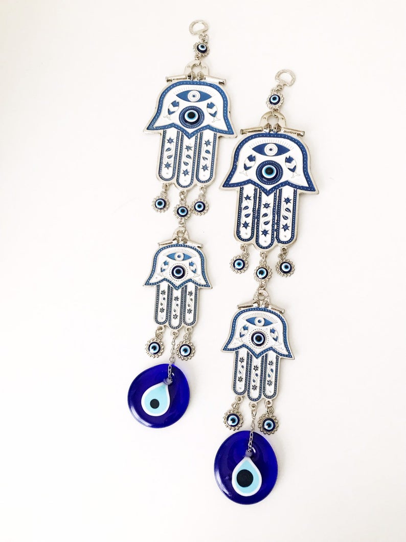 Hand of Fatima wall decor featuring evil eye beads, showcasing intricate metal craftsmanship and vibrant colors.