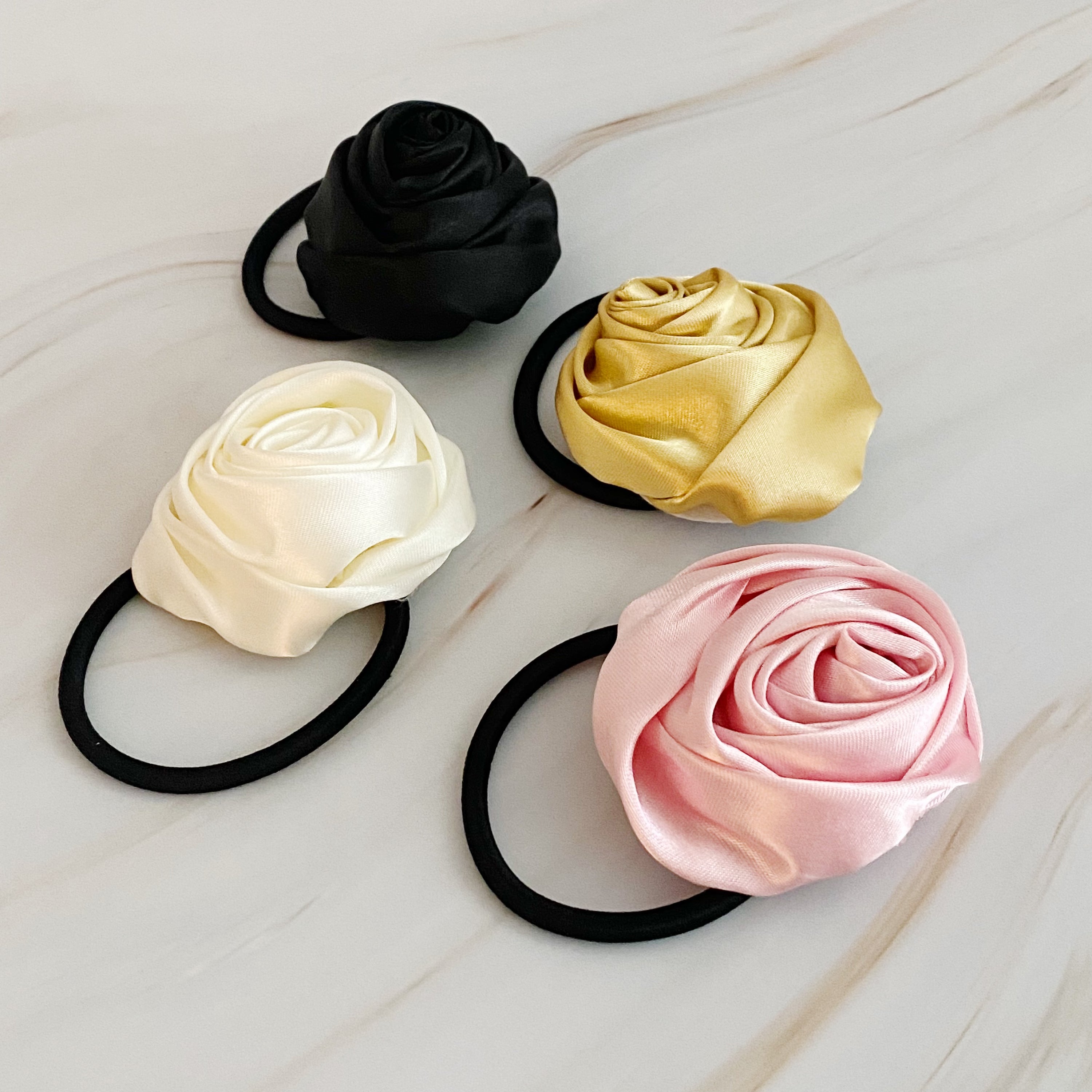 Hand Picked Satin Rose Hair Tie Set of 4 in neutral colors, featuring elegant rose-shaped designs.