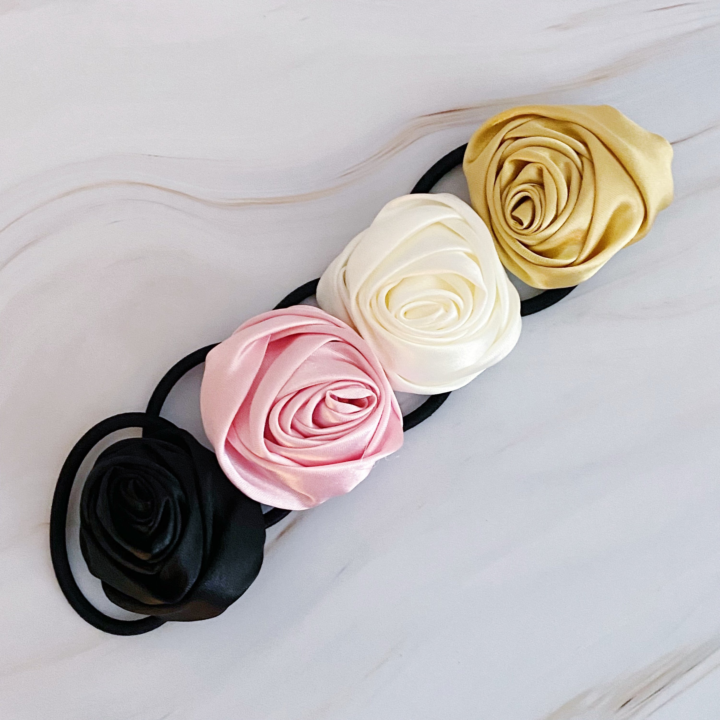 Hand Picked Satin Rose Hair Tie Set of 4 in neutral colors, featuring elegant rose-shaped designs.