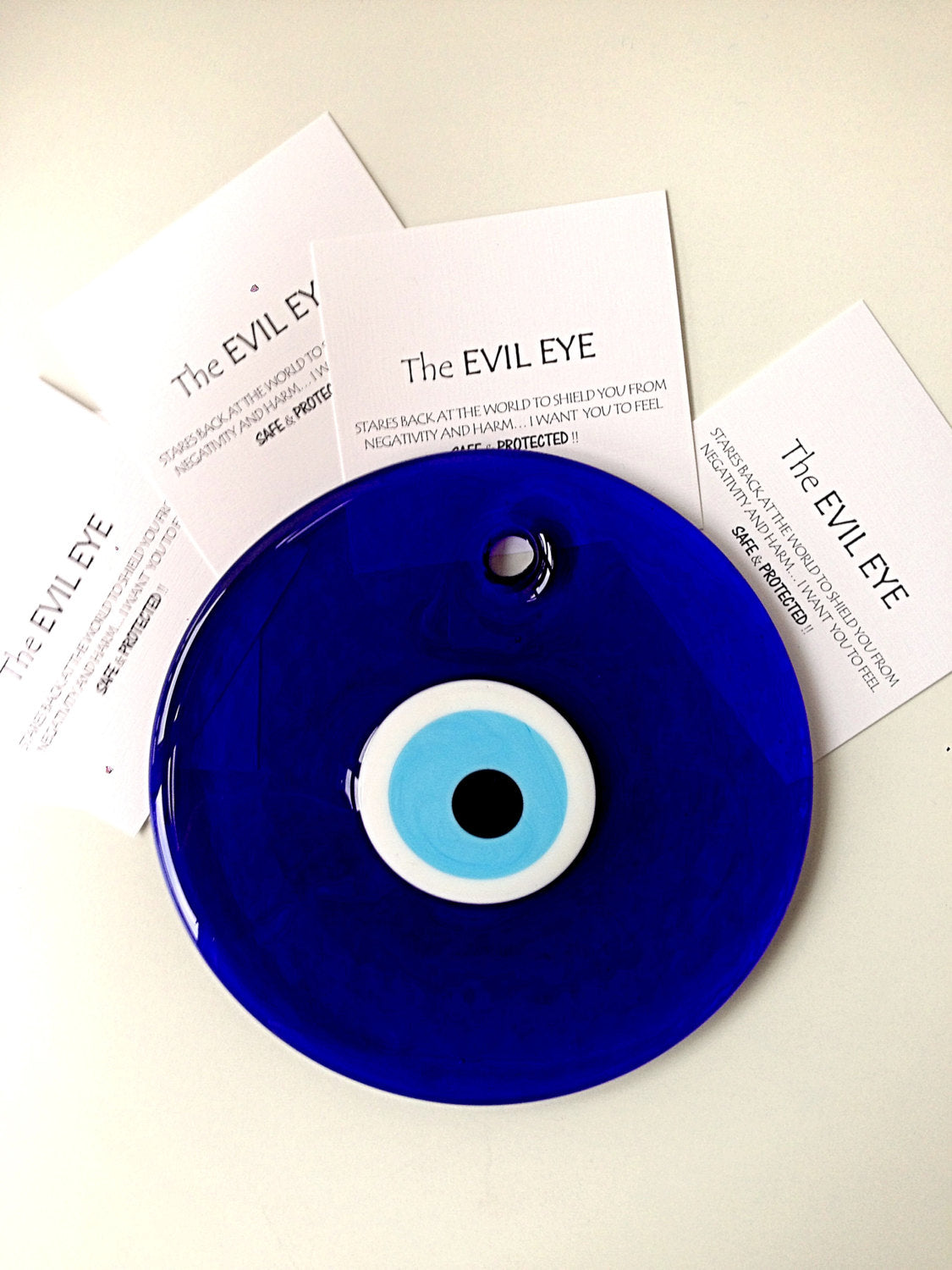 Handmade blue evil eye bead wall hanging, 26cm, featuring a unique design and blue rope for easy display.