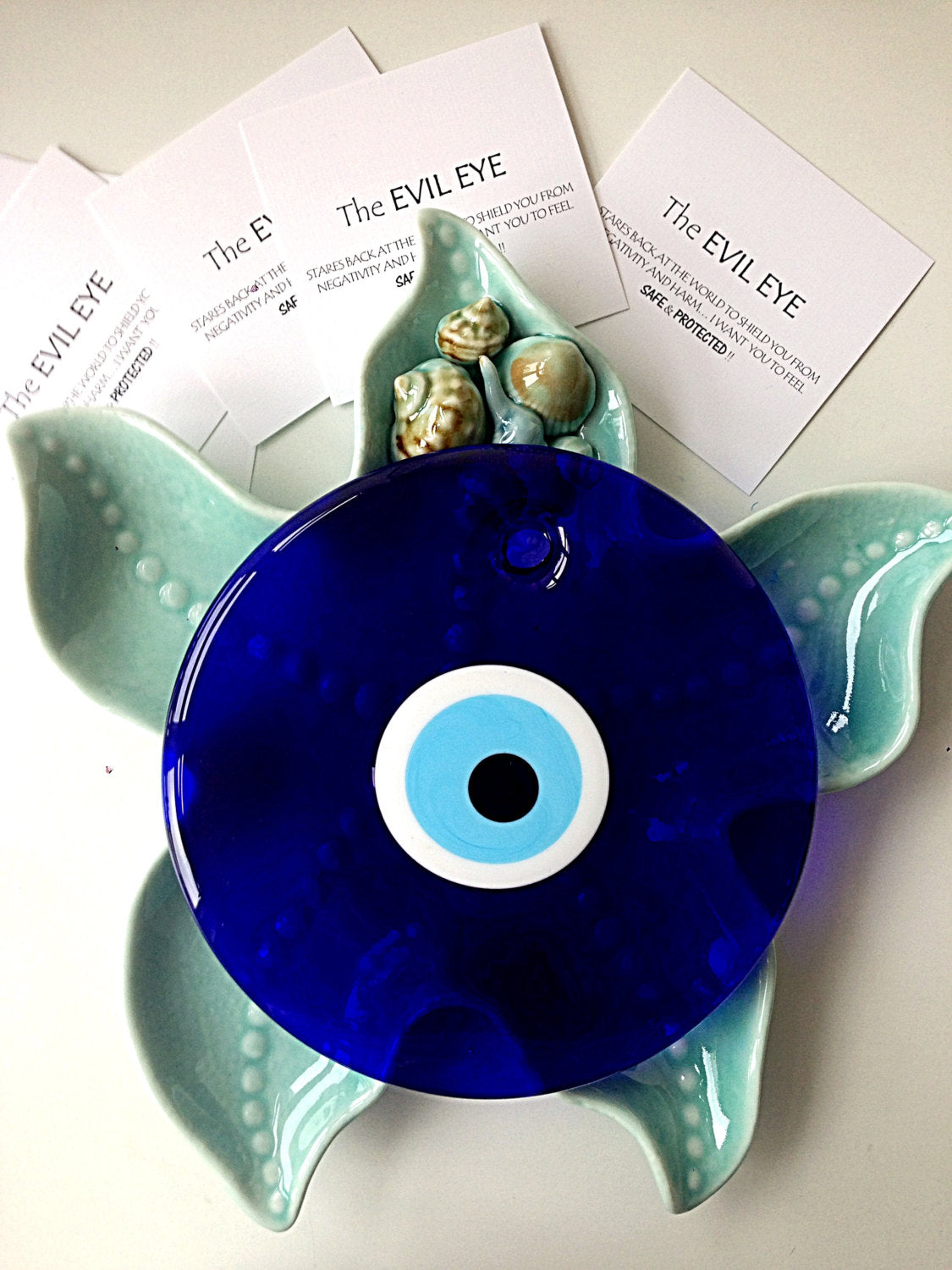 Handmade blue evil eye bead wall hanging, 26cm, featuring a unique design and blue rope for easy display.