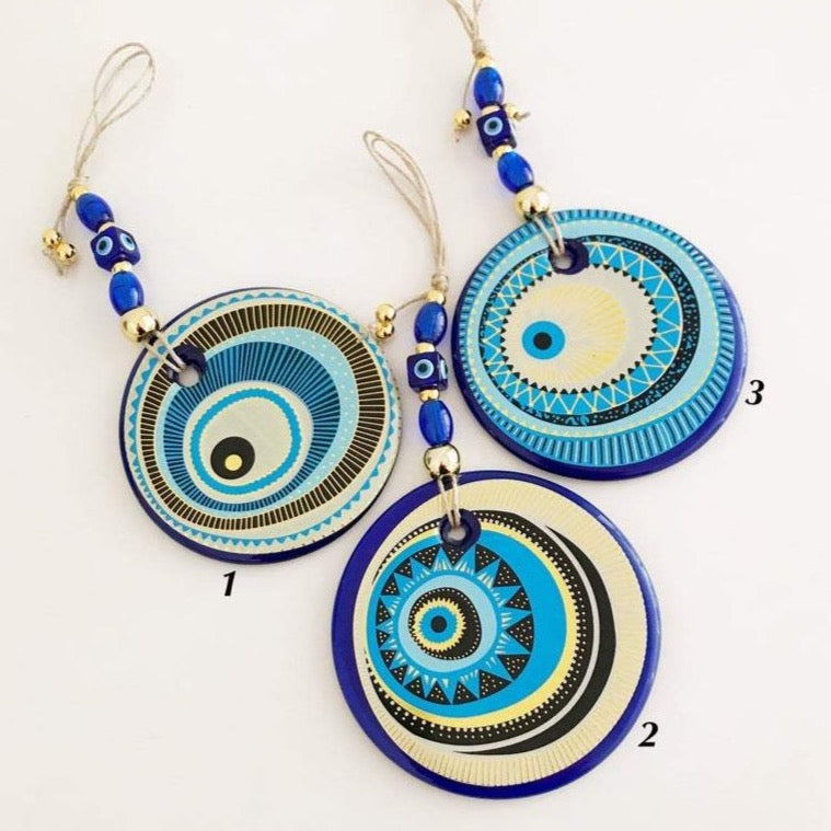 A beautifully crafted Handmade Evil Eye Wall Hanging featuring a large 13cm evil eye bead, showcasing intricate designs and vibrant colors.