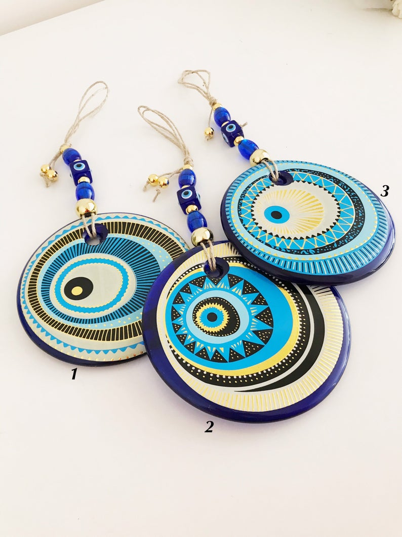 A beautifully crafted Handmade Evil Eye Wall Hanging featuring a large 13cm evil eye bead, showcasing intricate designs and vibrant colors.