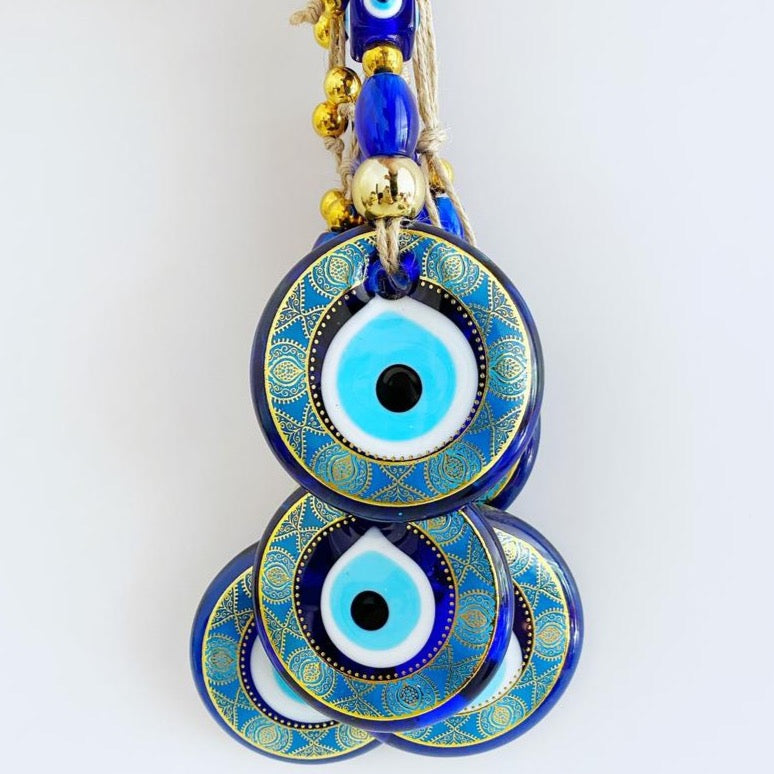 A beautifully crafted Handmade Evil Eye Wall Hanging featuring a vibrant blue evil eye motif, perfect for modern home decor.