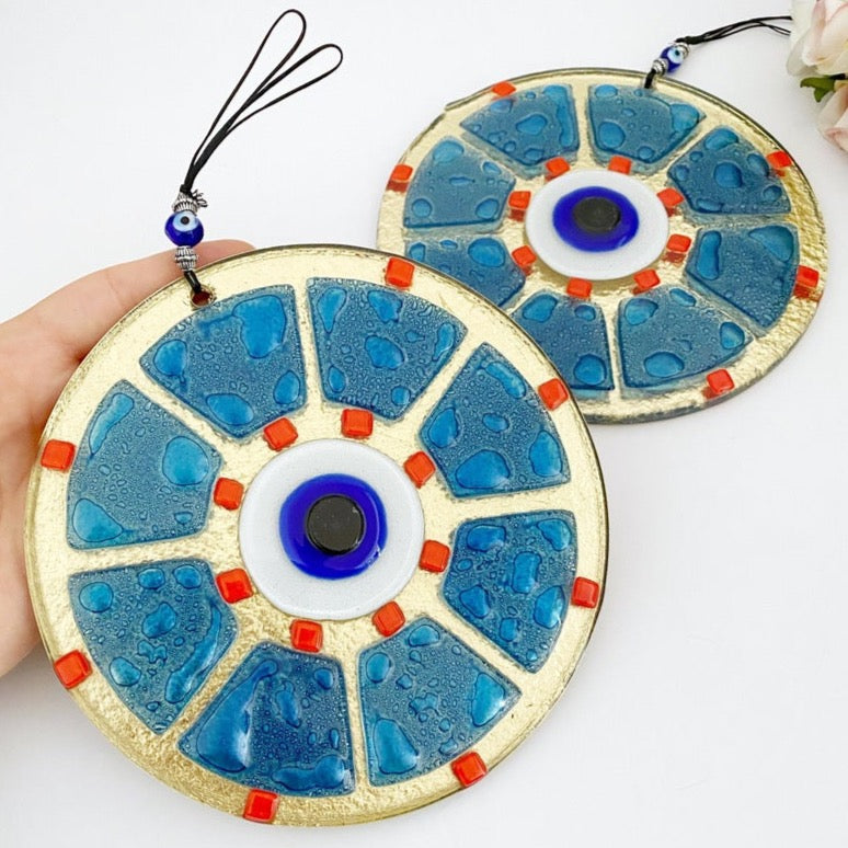 A beautifully crafted handmade glass evil eye bead in blue, featuring intricate designs, perfect for wall hanging and home decor.