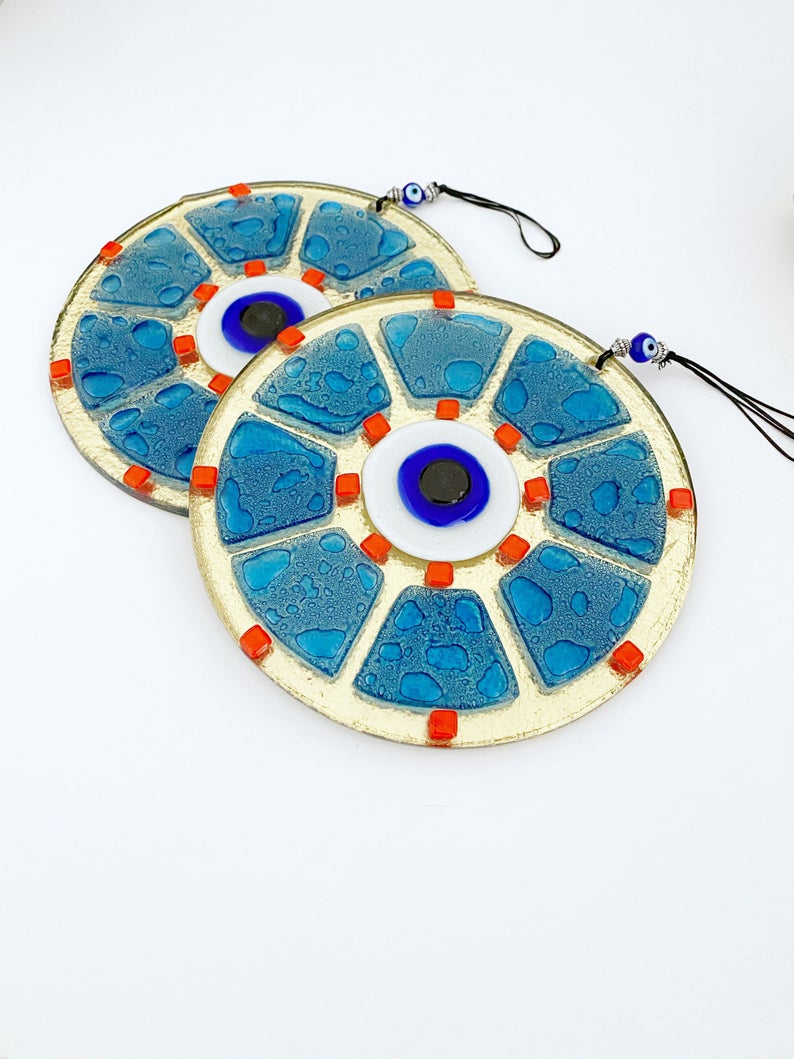 A beautifully crafted handmade glass evil eye bead in blue, featuring intricate designs, perfect for wall hanging and home decor.