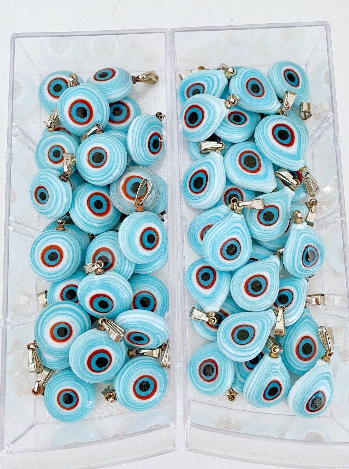 Handmade glass evil eye charm in turquoise, featuring round and oval shapes, perfect for jewelry making.