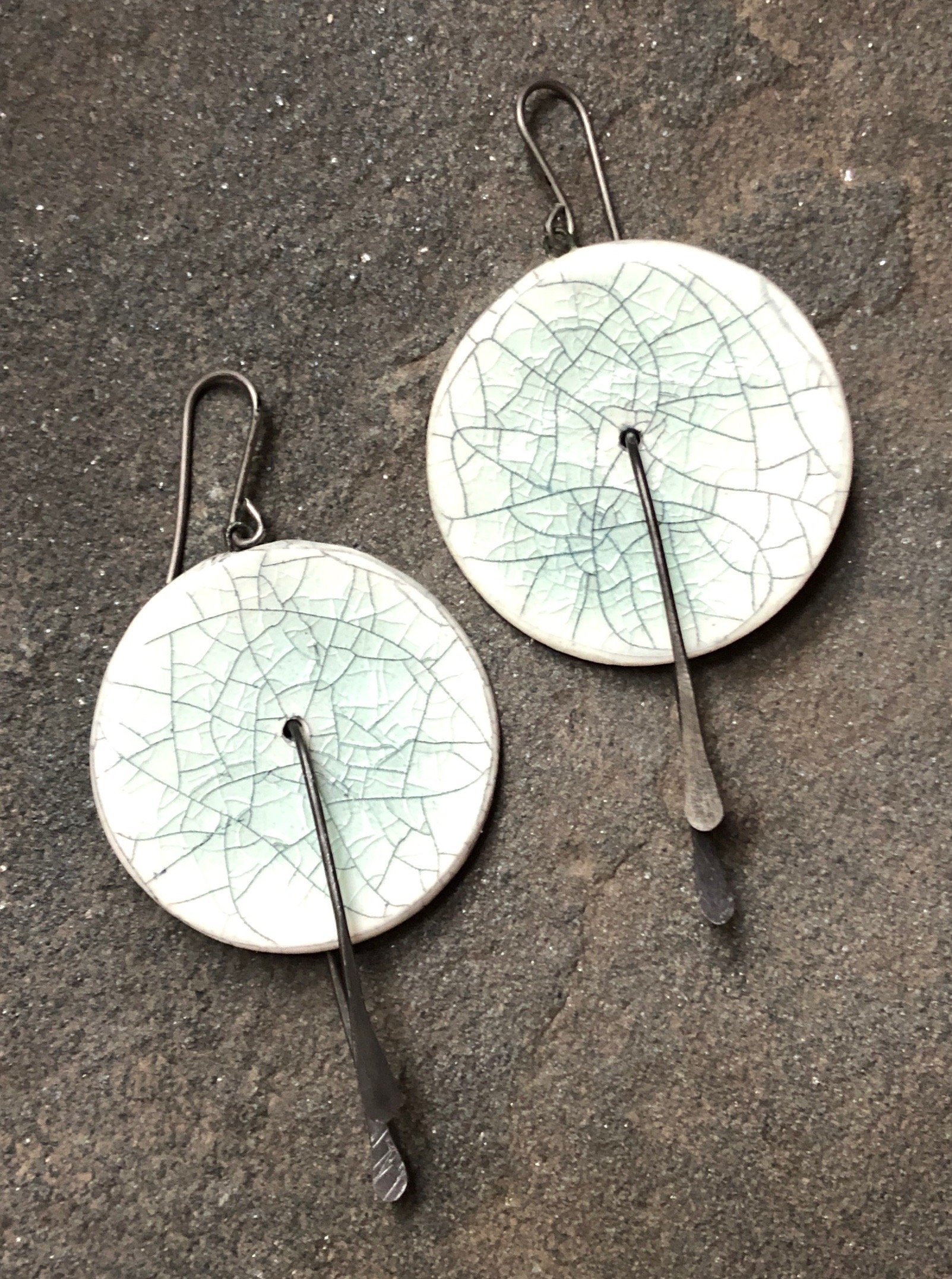 Handmade lightweight ceramic statement earrings with hypoallergenic titanium ear wires, featuring a unique design and 2-inch dangle length.