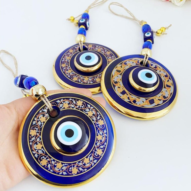 Handpainted Evil Eye Wall Hanging featuring blue glass accents, symbolizing protection and luck, measuring 29cm in length.