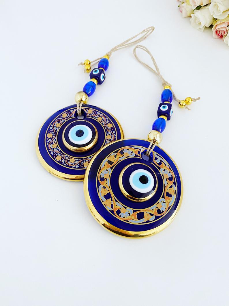 Handpainted Evil Eye Wall Hanging featuring blue glass accents, symbolizing protection and luck, measuring 29cm in length.