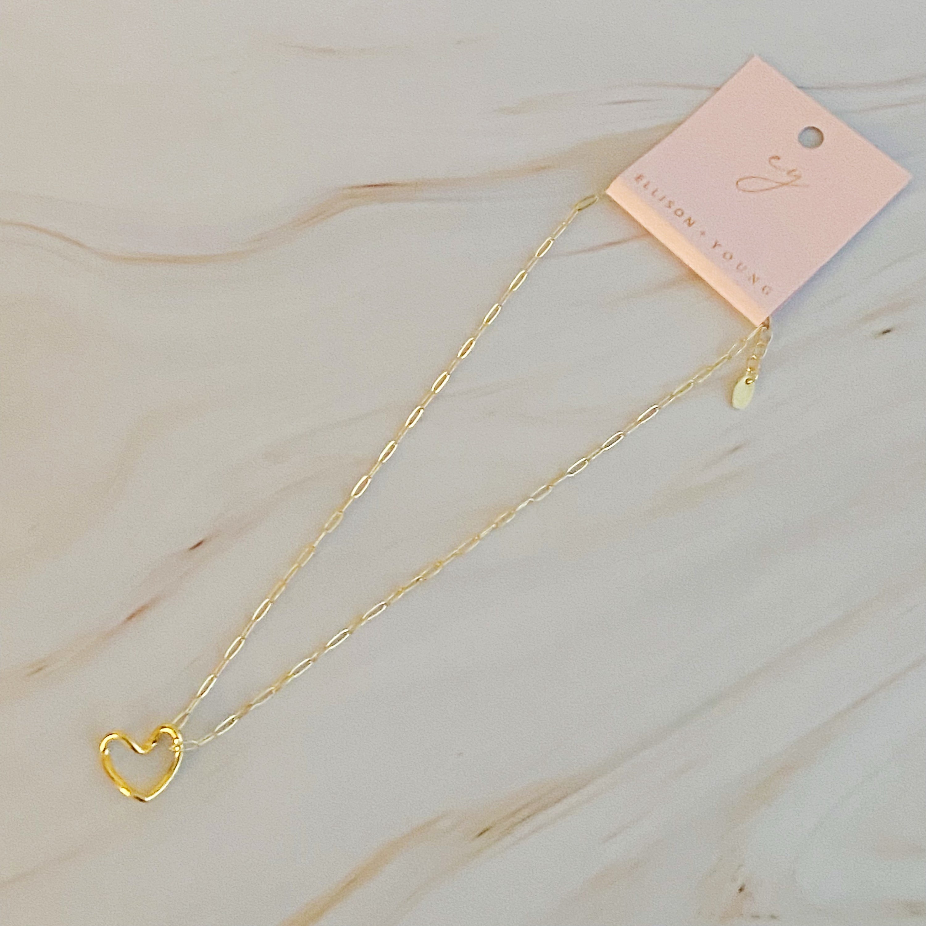 A stylish Heart and Chain Necklace featuring a hip heart pendant on a delicate link chain, perfect for everyday wear.