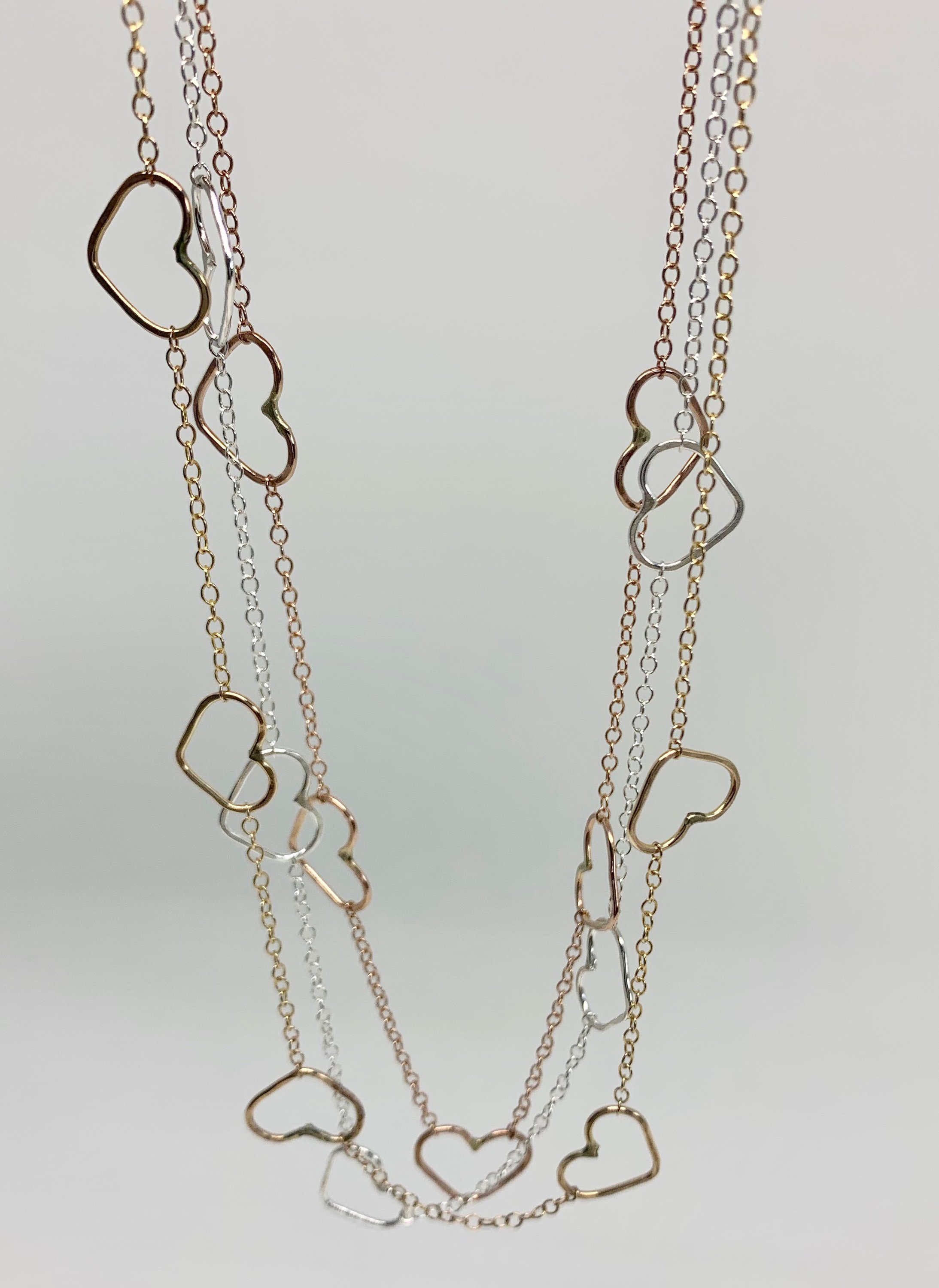 Handmade Heart Choker Necklace in sterling silver, rose gold fill, and yellow gold fill with textured hammered hearts.