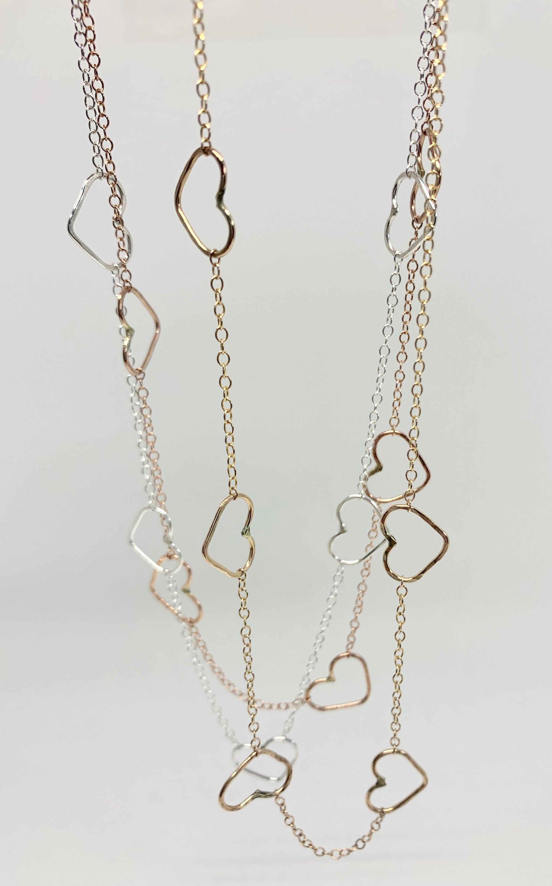 Handmade Heart Choker Necklace in sterling silver, rose gold fill, and yellow gold fill with textured hammered hearts.