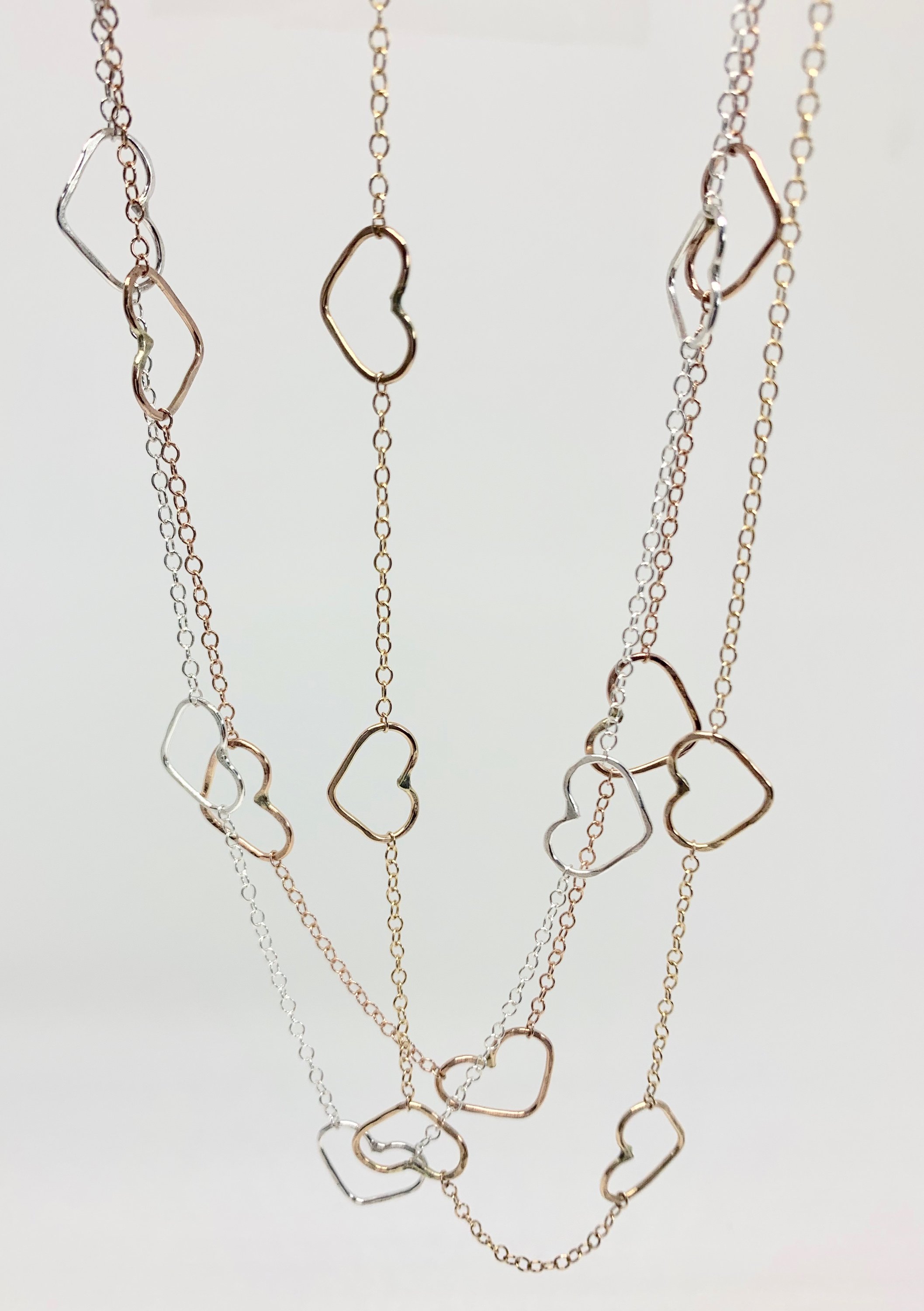 Handmade Heart Choker Necklace in sterling silver, rose gold fill, and yellow gold fill with textured hammered hearts.