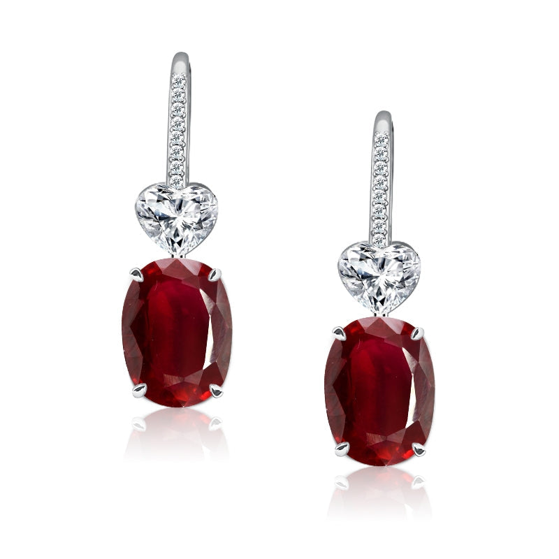 Elegant heart dangle earrings featuring a vibrant ruby stone and white sapphire, crafted from 925 sterling silver with a white gold finish.