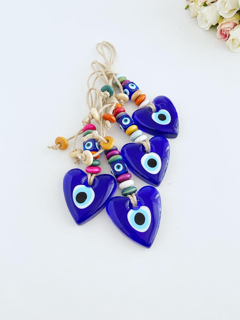 Heart Evil Eye Wall Hanging featuring glass beads and macrame design, perfect for home decor and protection.