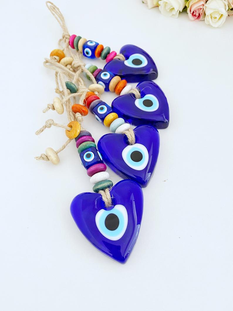 Heart Evil Eye Wall Hanging featuring glass beads and macrame design, perfect for home decor and protection.