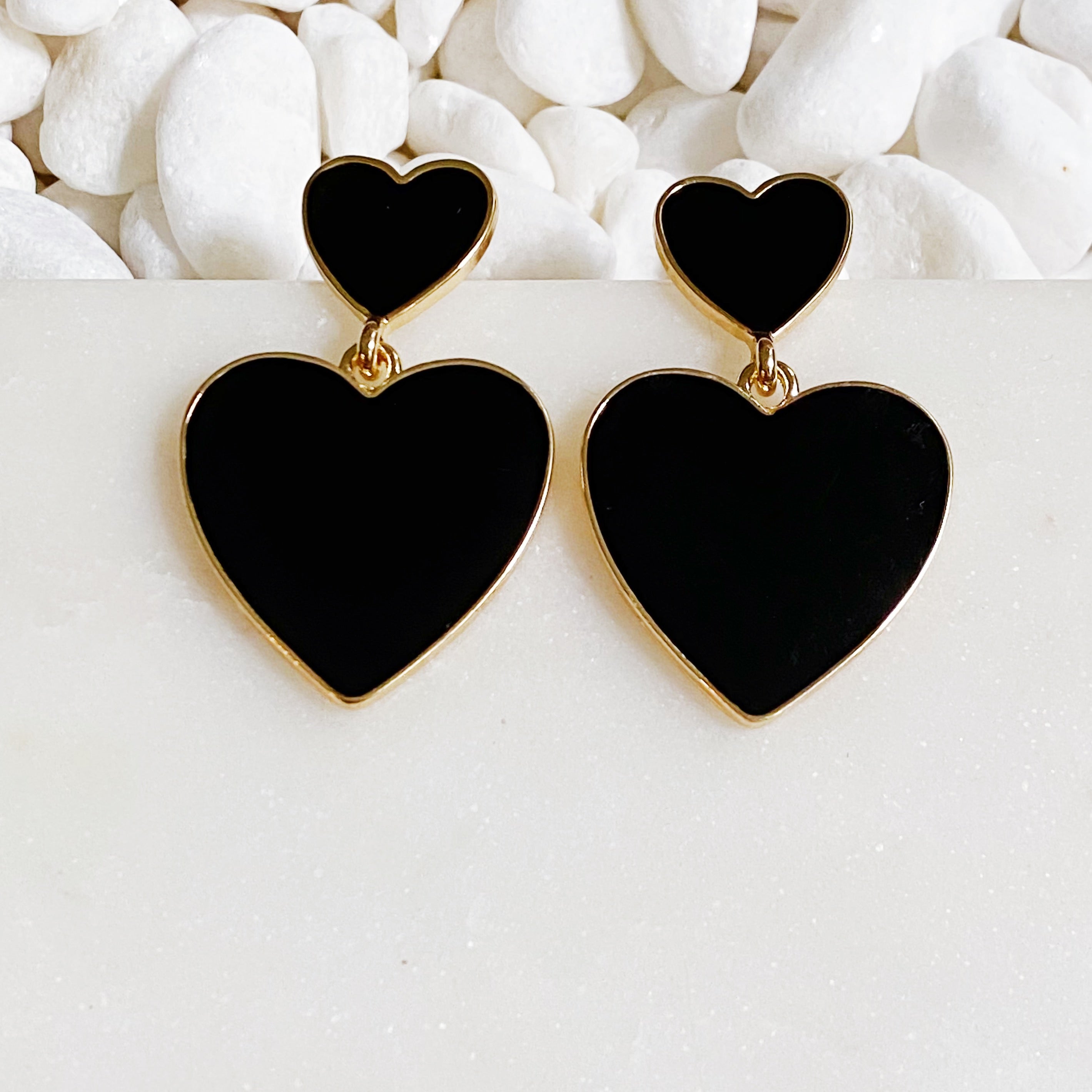 Trendy double heart earrings with glossy enamel finish in gold tone, perfect for game day or casual wear.