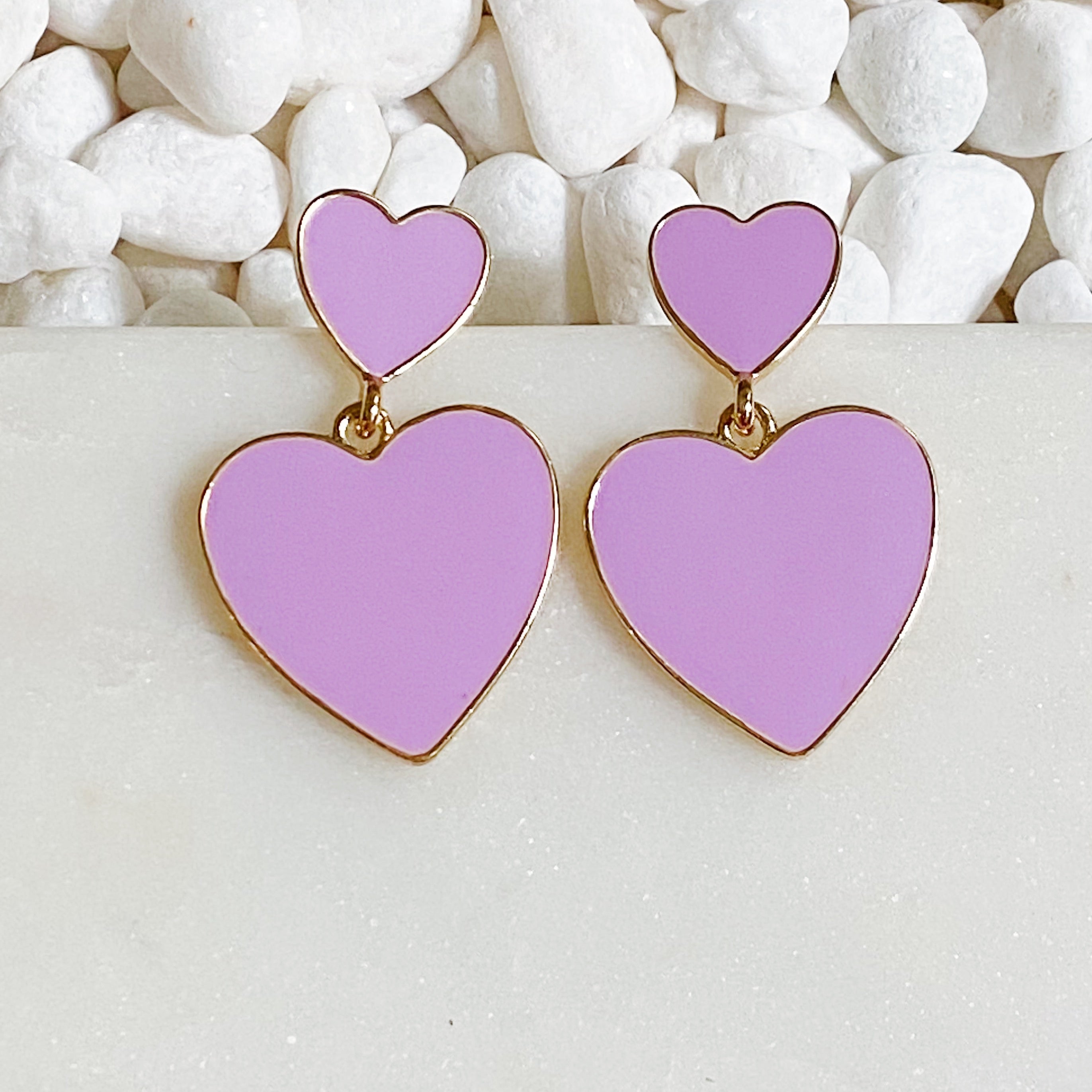 Trendy double heart earrings with glossy enamel finish in gold tone, perfect for game day or casual wear.