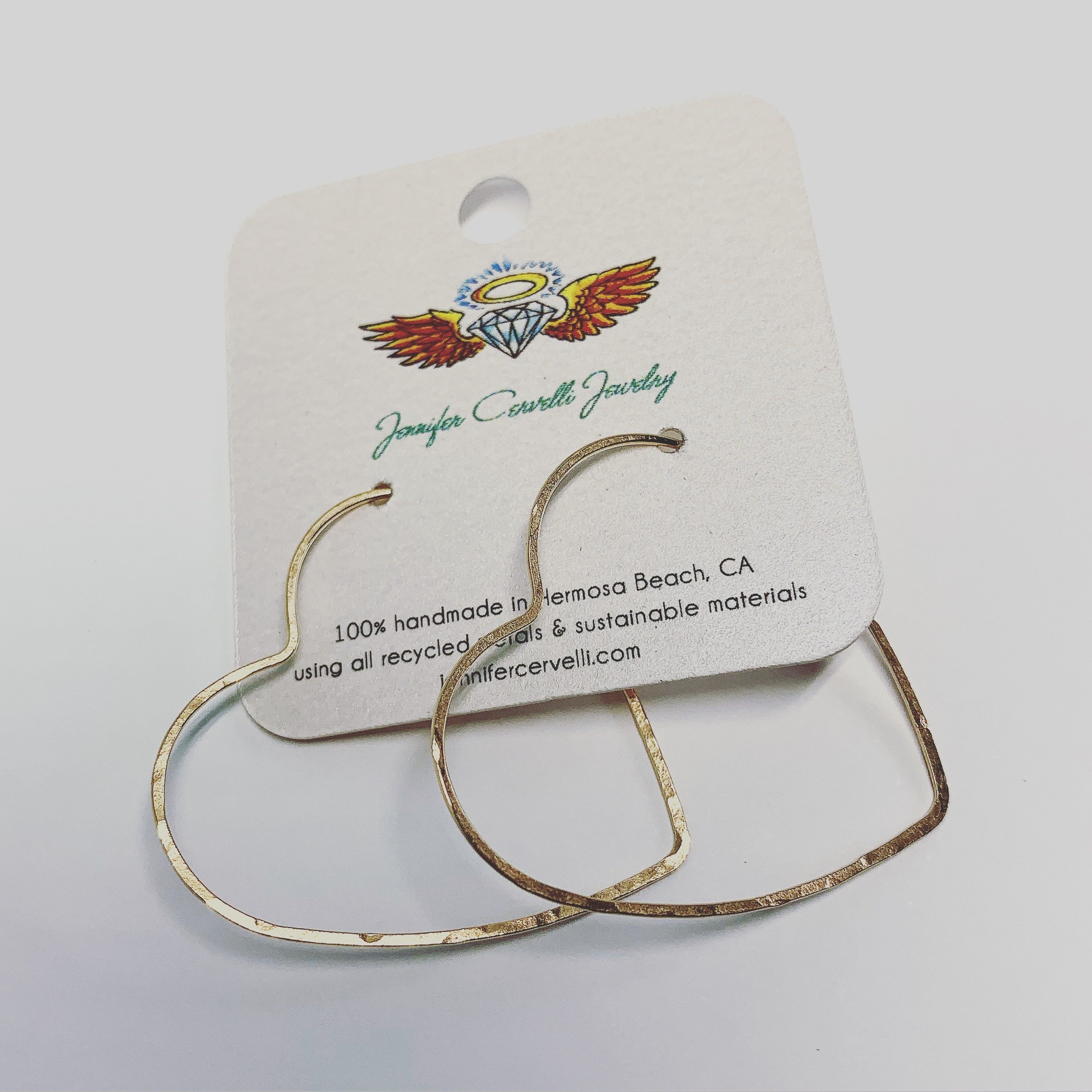 Large heart-shaped hoops made from 20 gauge wire, featuring a hammered texture for shine, available in silver, yellow gold fill, and rose gold fill.