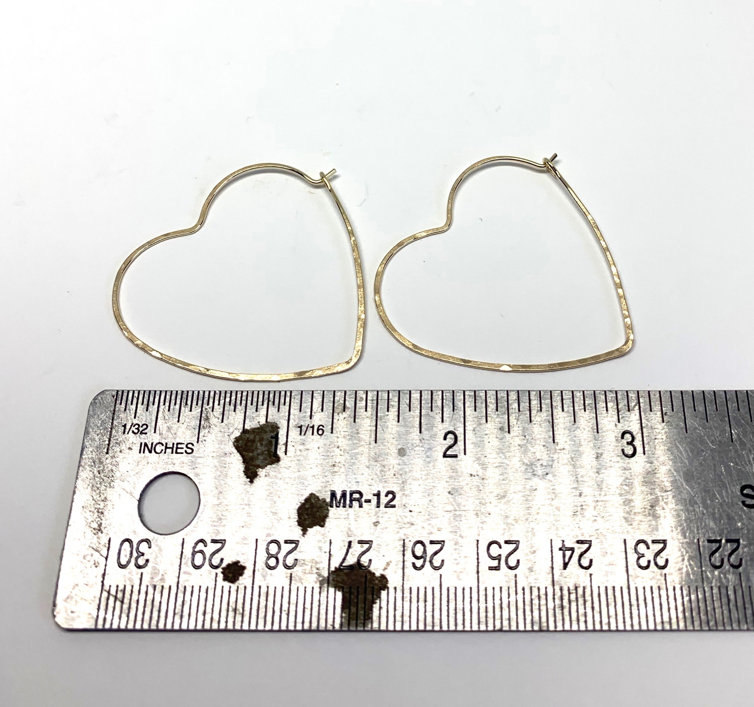 Large heart-shaped hoops made from 20 gauge wire, featuring a hammered texture for shine, available in silver, yellow gold fill, and rose gold fill.