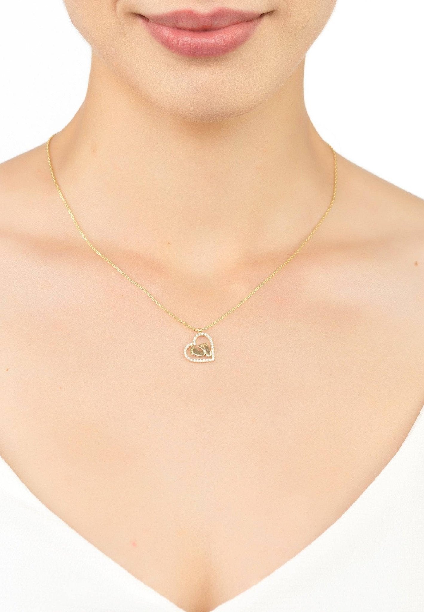 Heart Mum Pendant Necklace in gold, featuring an open heart design with tiny feet and sparkling cubic zirconia.