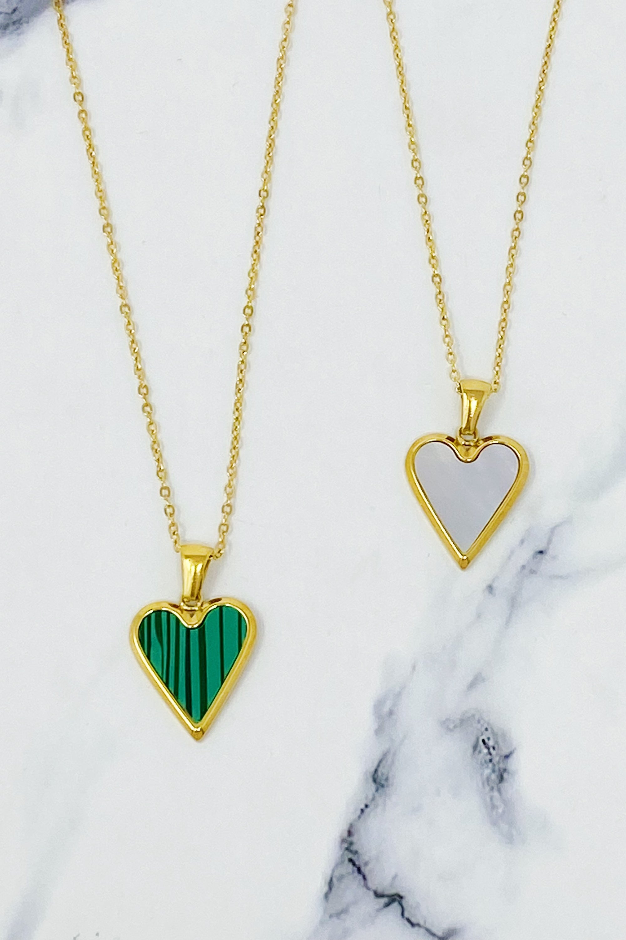 Heart Of Gold Necklace featuring a dainty gold chain and an enamel heart pendant, showcasing elegance and charm.