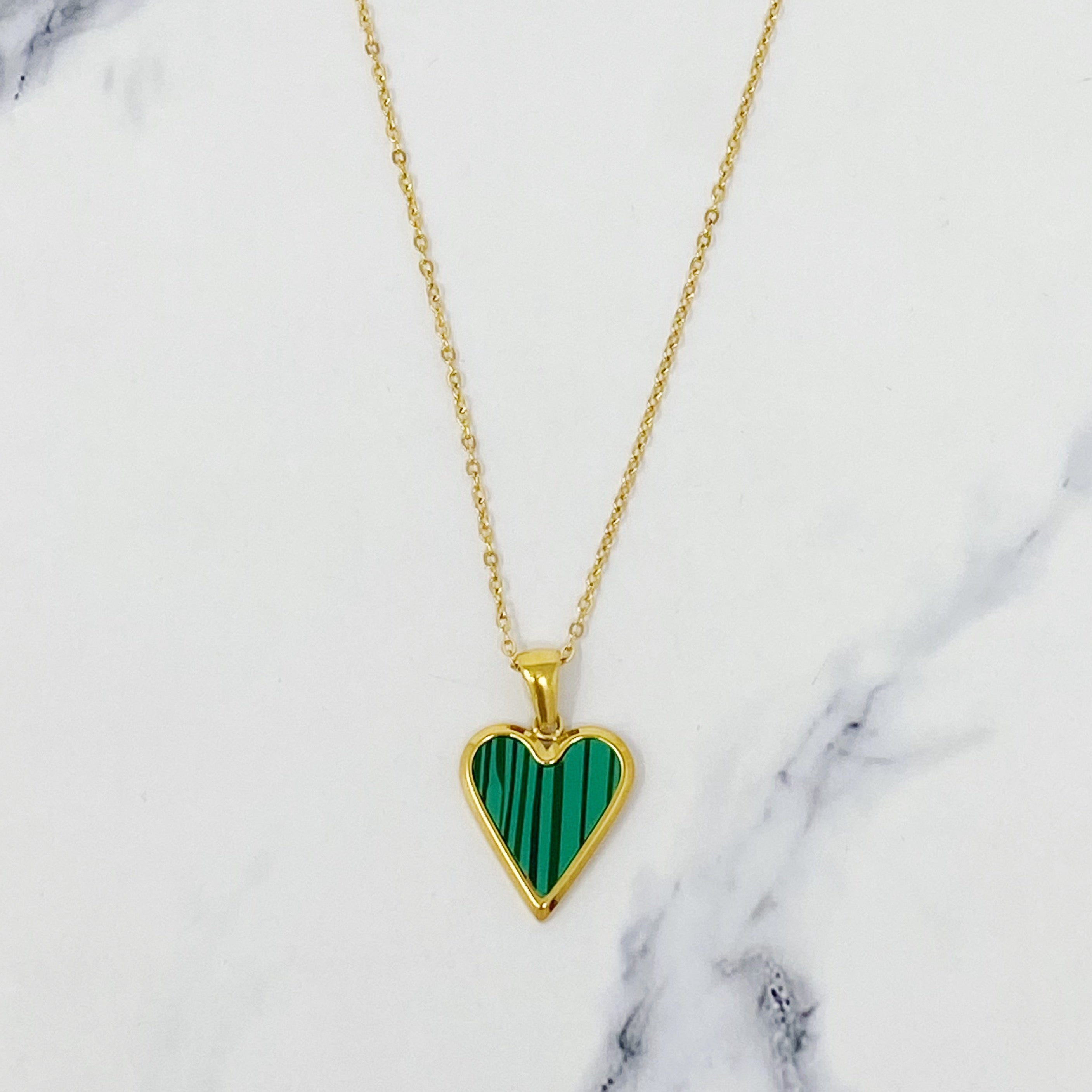 Heart Of Gold Necklace featuring a dainty gold chain and an enamel heart pendant, showcasing elegance and charm.