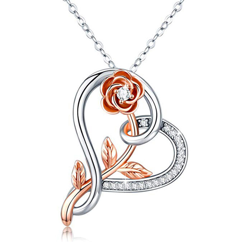 A silver plated heart pendant necklace featuring a rose flower design and sparkling zircon stones on a link chain.