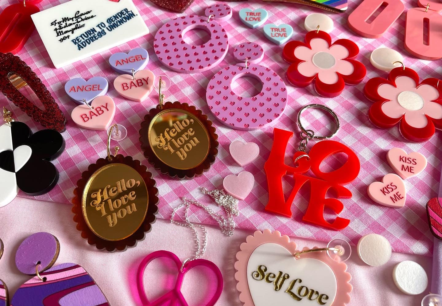 A pair of stylish Heart Print Hoop Earrings featuring a playful heart design, made from laser cut acrylic, showcasing vintage-inspired fashion.