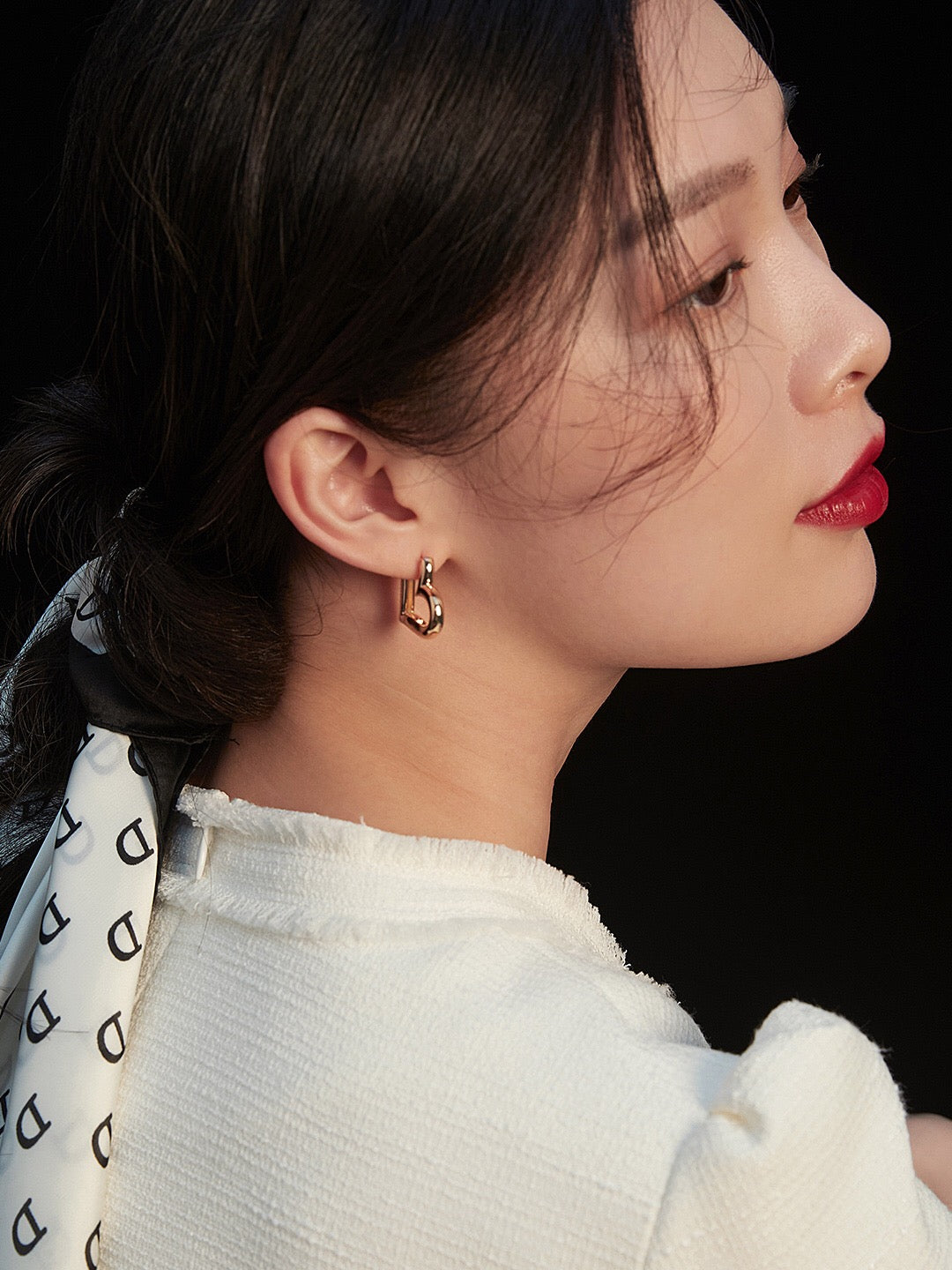 A pair of elegant heart shape hoop earrings made from sterling silver with a gold vermeil finish, showcasing their unique design and craftsmanship.