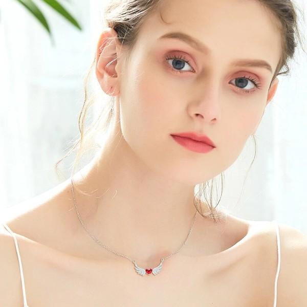 Heart Shaped Angel Wings Necklace in 14K white gold plating with red Elements stones, featuring a delicate heart-shaped pendant and link chain.