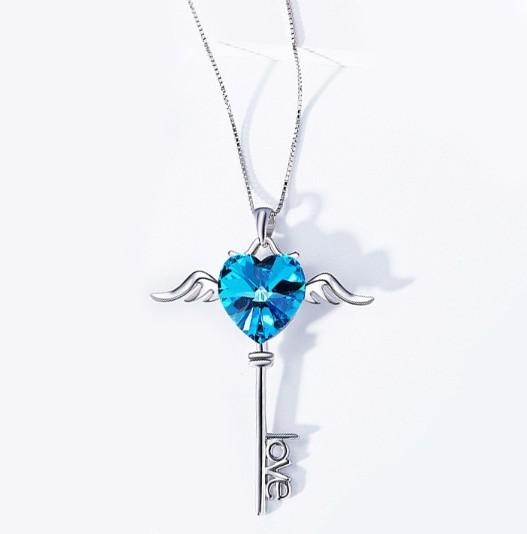 Heart shaped blue elements dangling key necklace in 14K white gold, featuring a beautiful blue pendant and a link chain.