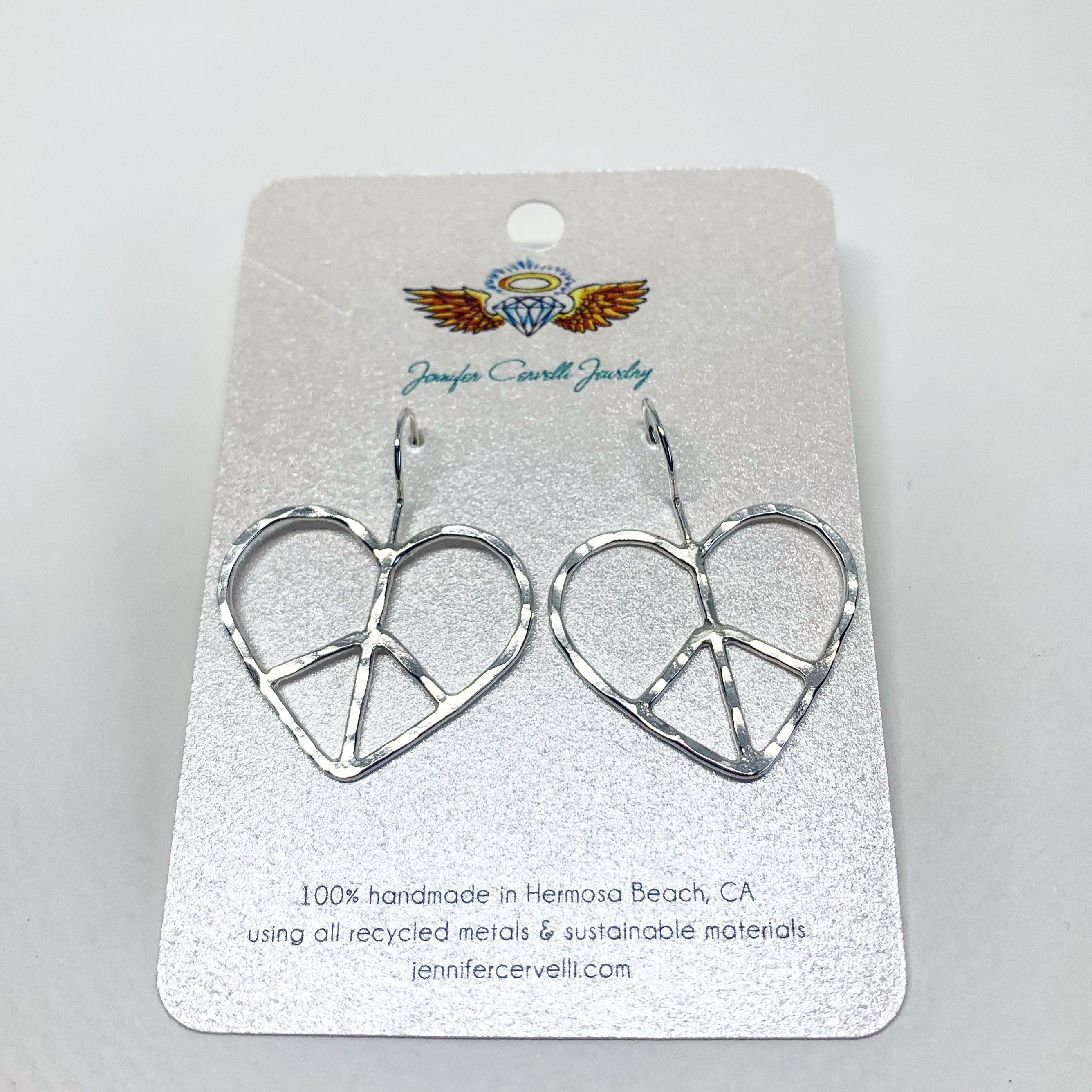 Handmade heart shaped peace sign earrings with a rustic hammered texture, crafted from recycled metals in Hermosa Beach, California.