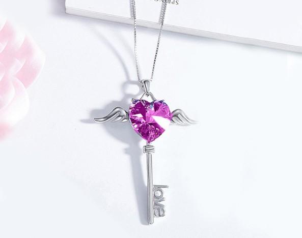 Heart shaped pink elements dangling key necklace in 14K white gold, featuring a delicate link chain and lobster clasp.