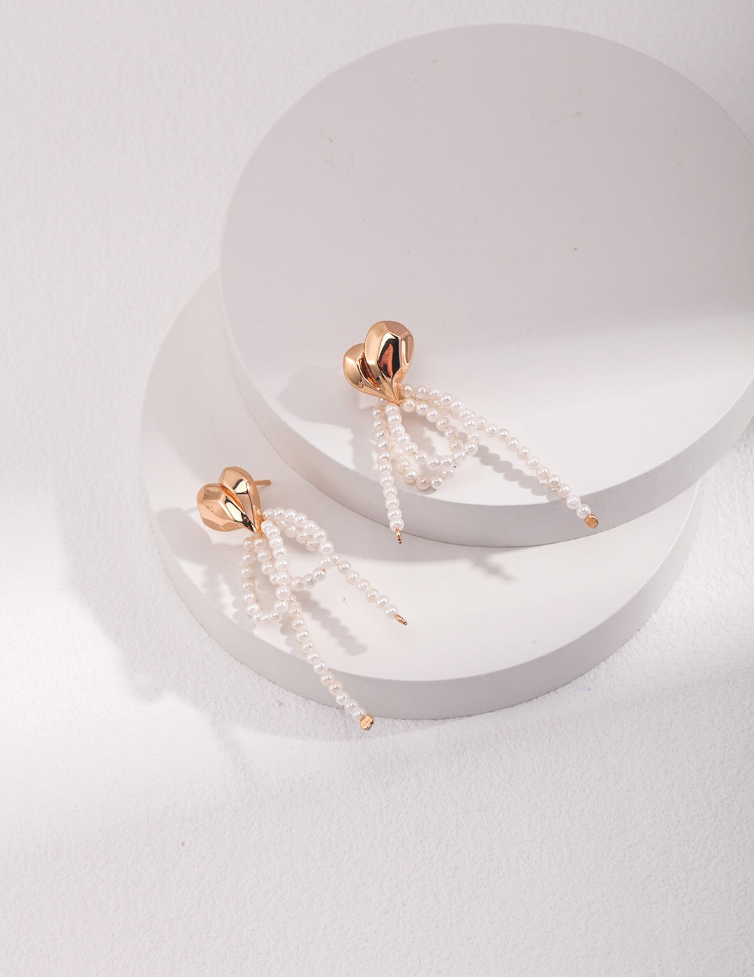 Elegant Heart Shell Dangle Earrings featuring shell beads and gold vermeil, showcasing a unique handmade design.