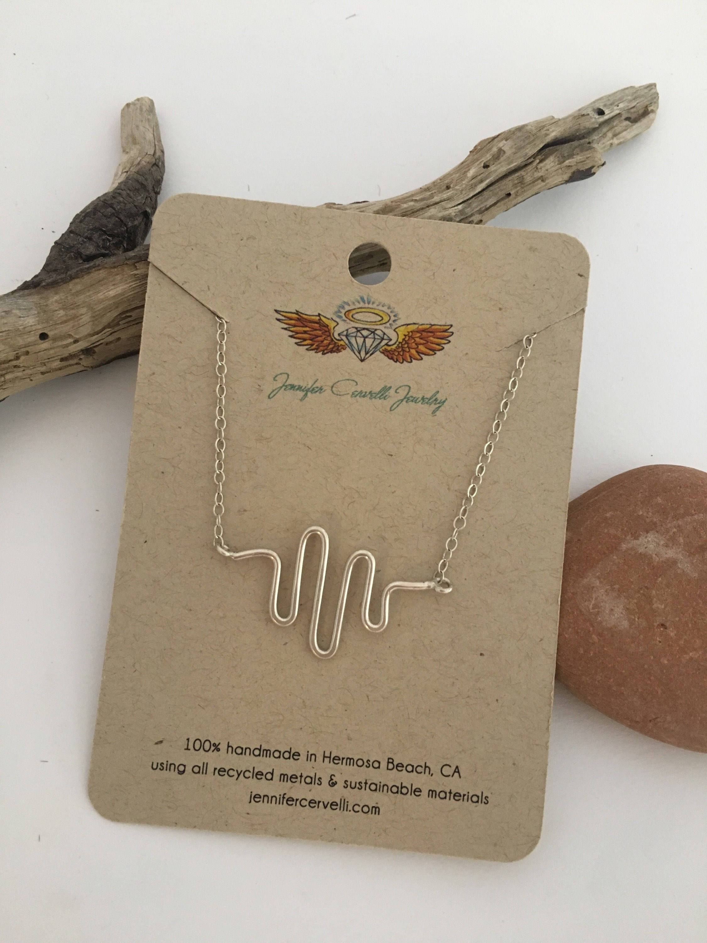 A handcrafted Heartbeat Necklace made from 16 gauge wire, featuring a unique heartbeat pendant attached to an adjustable chain.