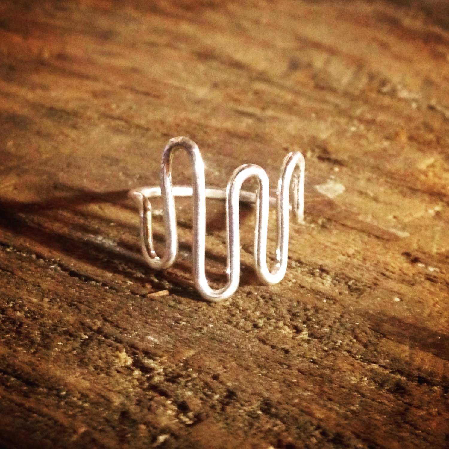 A handcrafted Heartbeat Ring made from 16 gauge round wire, featuring a unique hammered texture, symbolizing love and life.