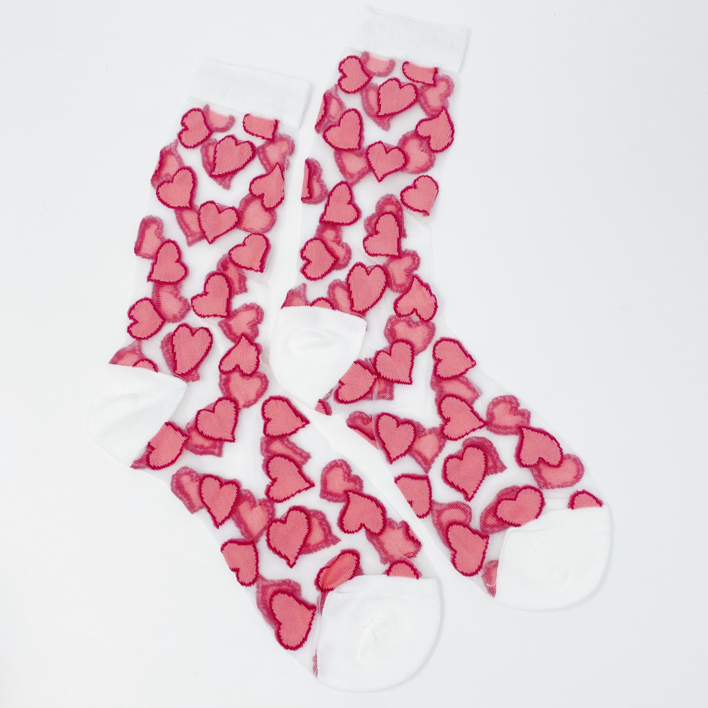 A pair of sheer socks featuring a playful heart pattern, showcasing their soft texture and stylish design.