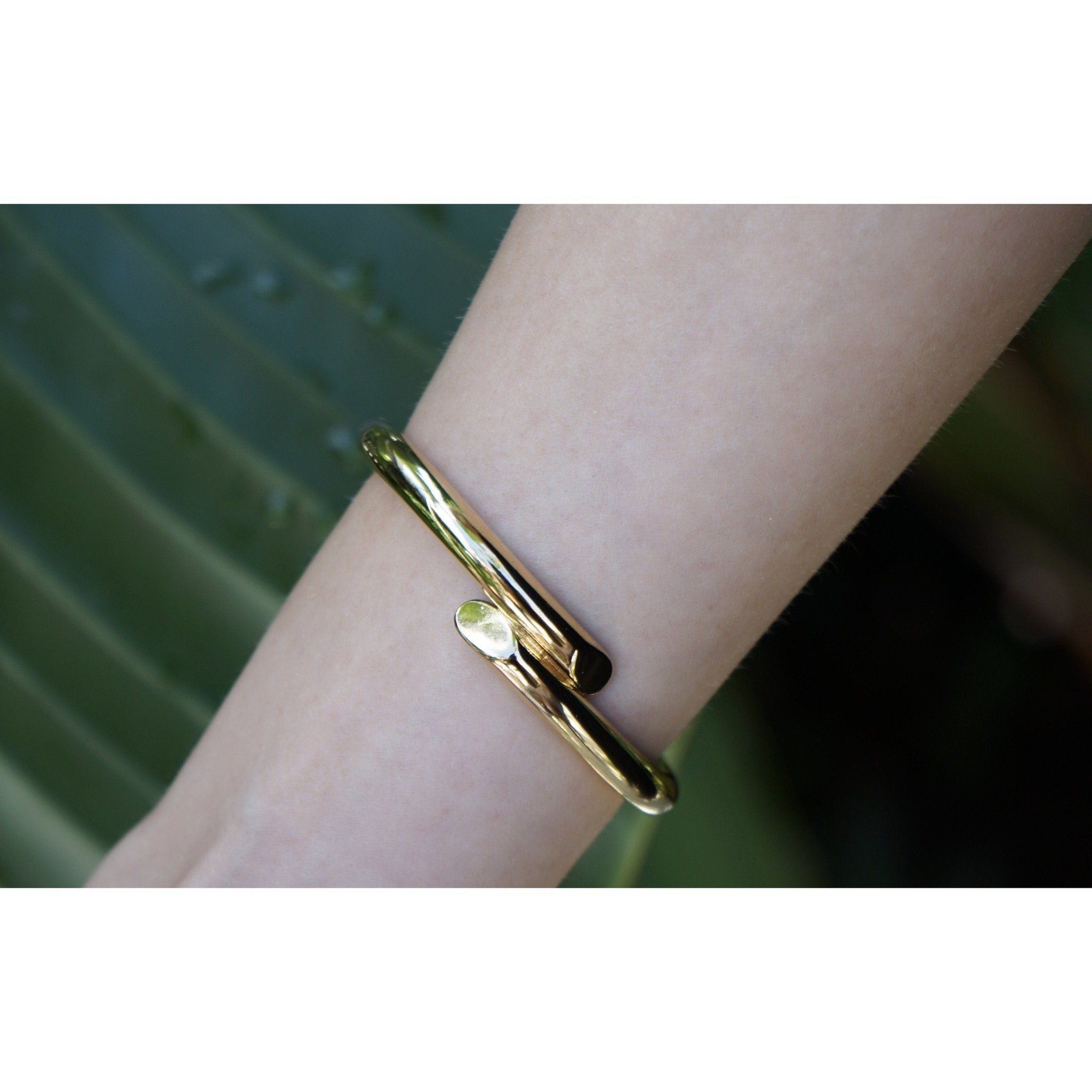 Helen Cuff, a gold-plated stainless steel bracelet, elegantly designed for layering with other bracelets.