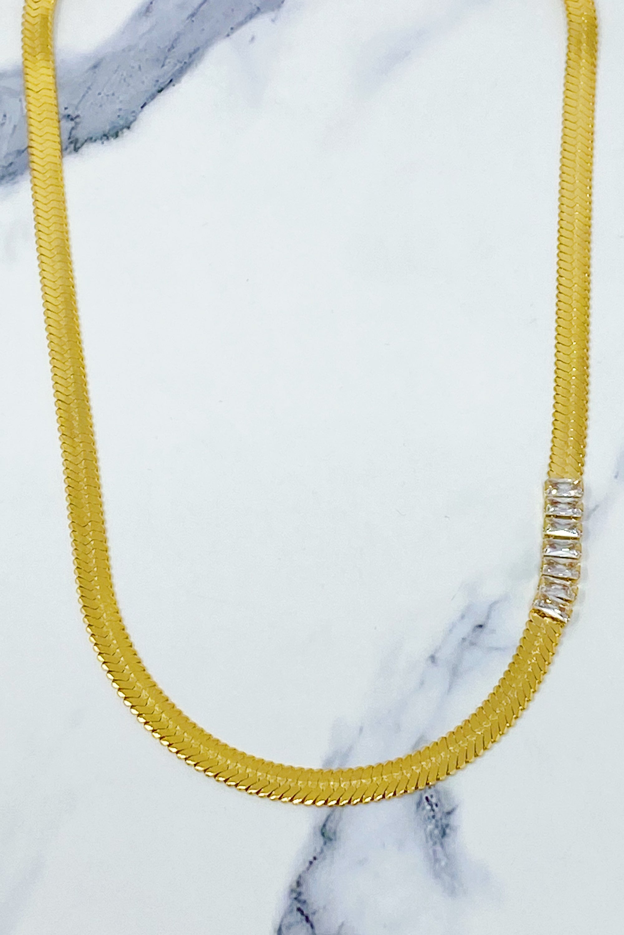 Elegant Herringbone Jeweled Necklace with cubic zirconia jewels, showcasing a chic design and gold plating.