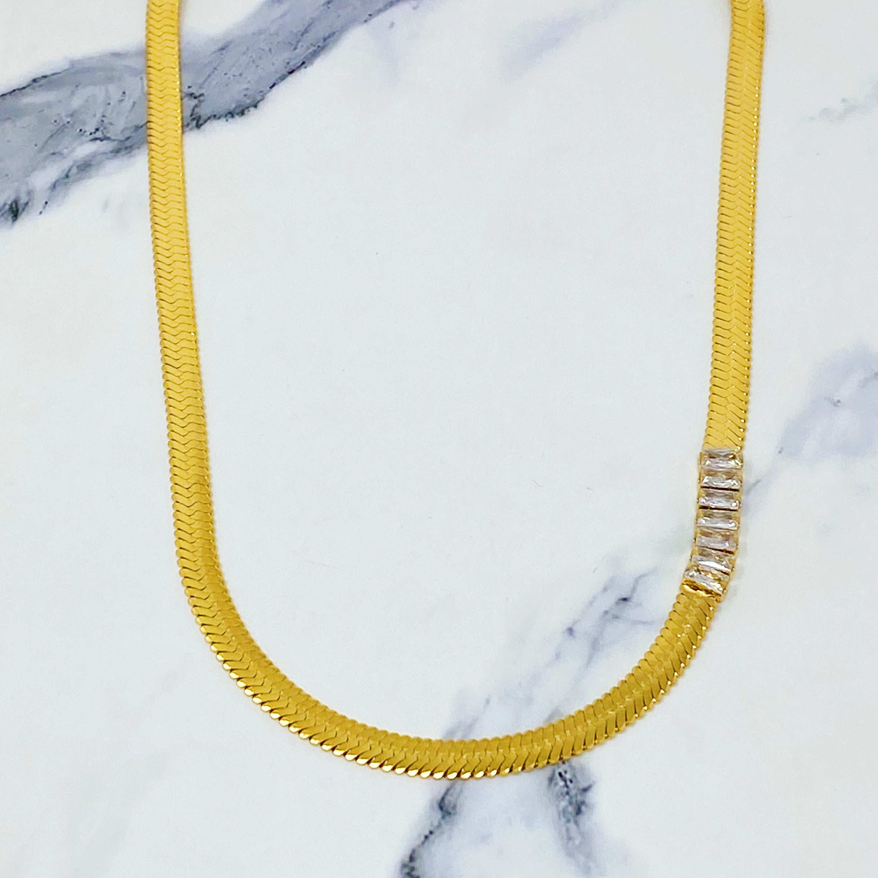 Elegant Herringbone Jeweled Necklace with cubic zirconia jewels, showcasing a chic design and gold plating.