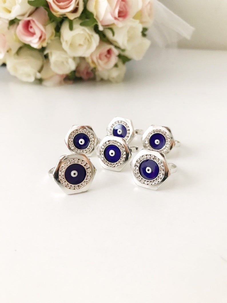 A beautiful Hexagon Evil Eye Ring featuring a blue evil eye bead on an adjustable silver band, symbolizing protection and style.