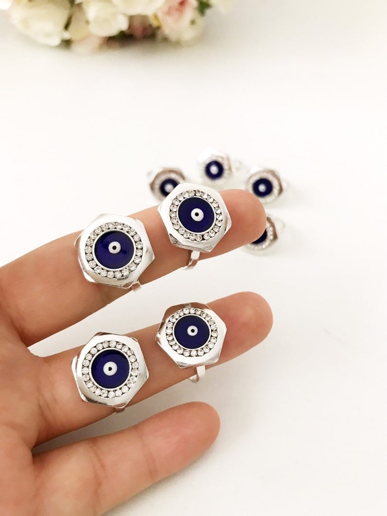 A beautiful Hexagon Evil Eye Ring featuring a blue evil eye bead on an adjustable silver band, symbolizing protection and style.