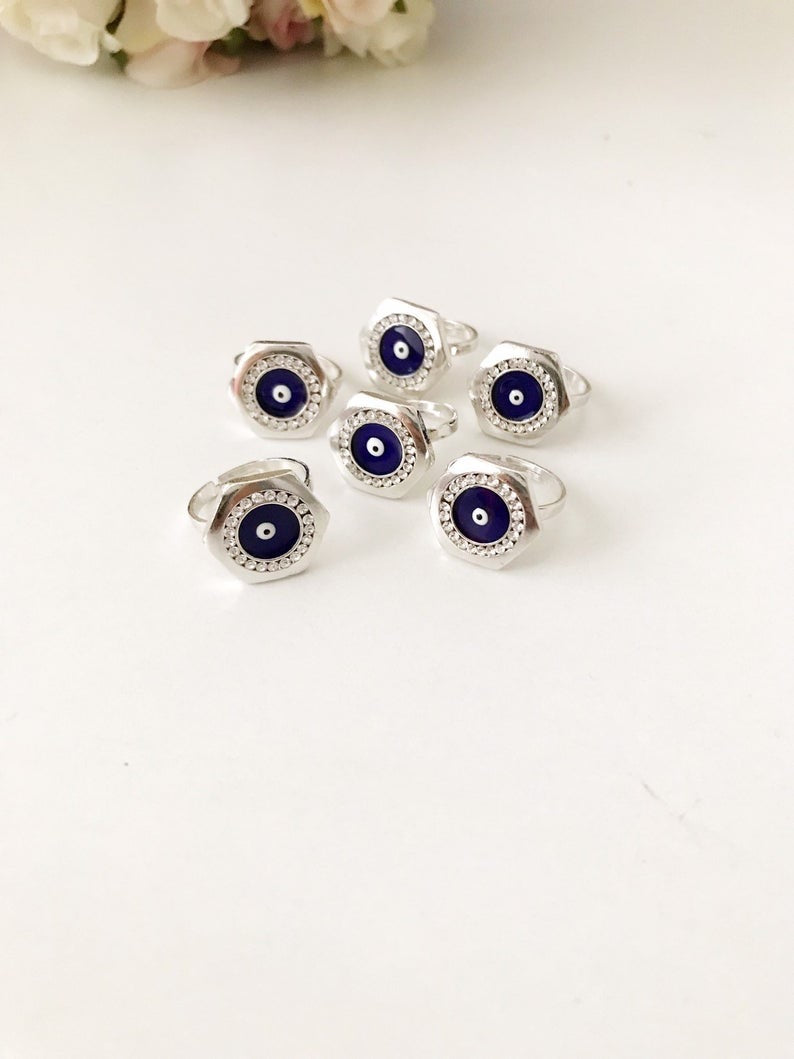 A beautiful Hexagon Evil Eye Ring featuring a blue evil eye bead on an adjustable silver band, symbolizing protection and style.