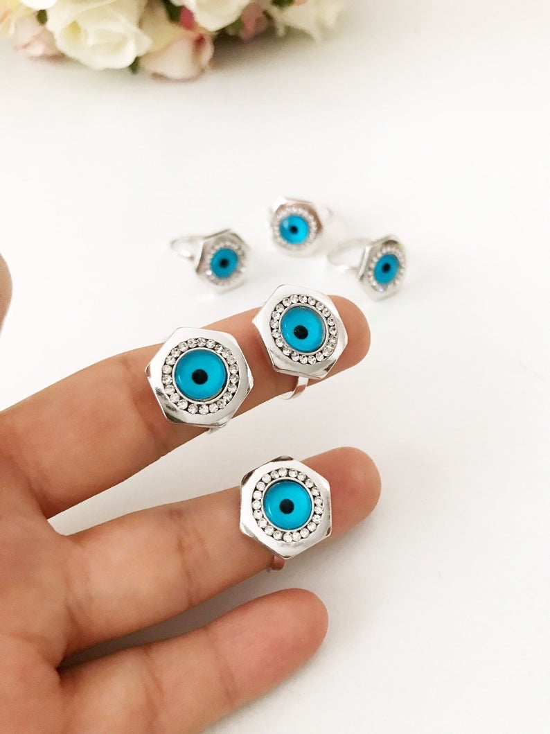 Hexagon Evil Eye Ring featuring a blue evil eye bead on an adjustable silver band, symbolizing protection and good luck.